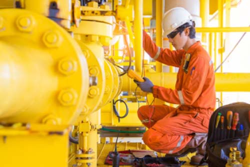 A technician inspecting a pipeline system